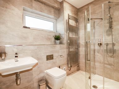 A bathroom with sink, toilet, and shower at Harber Rise in Carlyon Bay