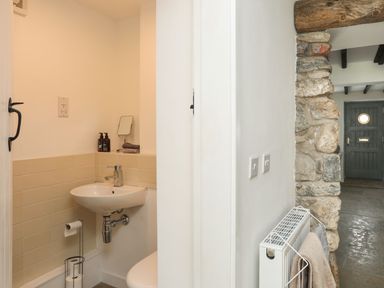 A bathroom with a sink and toilet at Swn y Mor (Wexham) Beaumaris