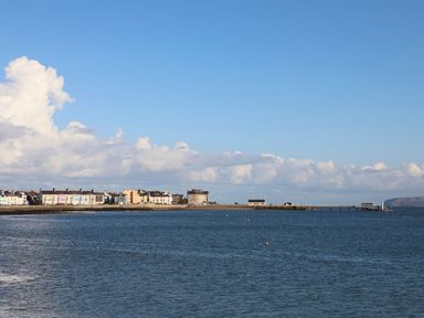 A coastal view with houses and a pier at Swn y Mor (Wexham) Beaumaris