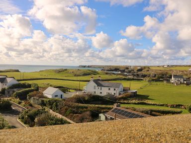 A view of the ocean and houses at Llywelyn in Trearddur Bay