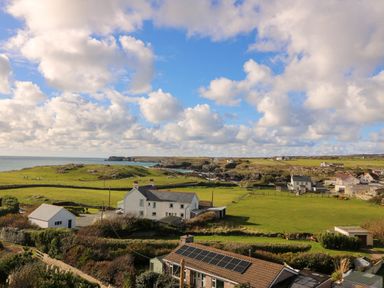 A view of fields and houses near the sea at Llywelyn in Trearddur Bay