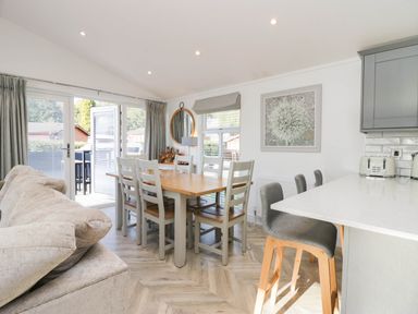 A dining room with a table and chairs at Thirlmere Scar in Troutbeck Bridge