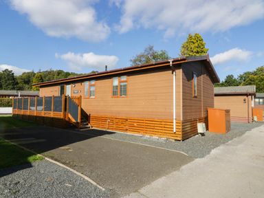 A wooden cabin with a deck and steps at Thirlmere Scar Troutbeck Bridge