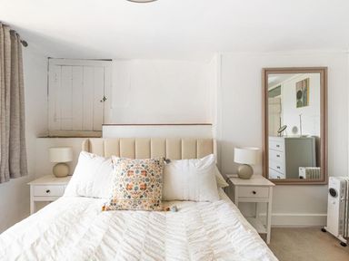 A bedroom featuring a bed, bedside tables and a mirror at The Old Barn in Manchester