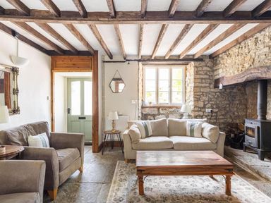 A living room with a sofa and armchair at a property