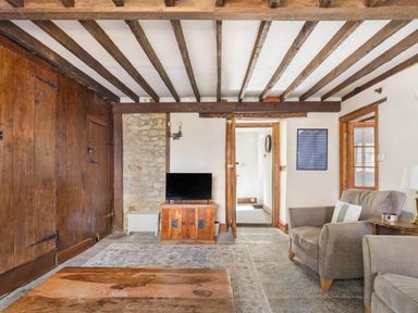 A living room with a television and armchair at the property