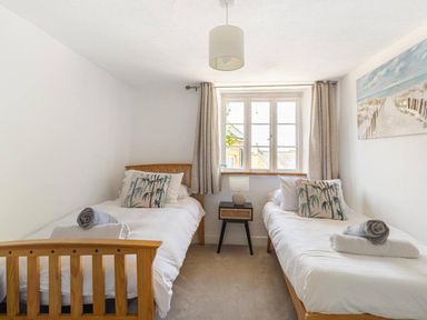 A bedroom with two beds and a window at The Old Barn in Manchester