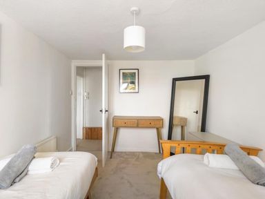 A bedroom with two beds and a desk at The Old Barn in Manchester
