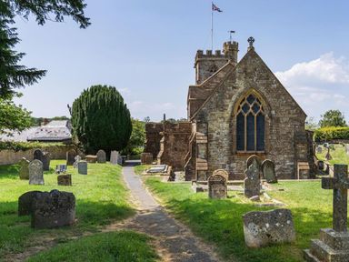 A church building with a graveyard and pathway at the location