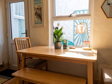 A dining room with a table and chairs at a property