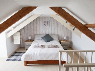 A bedroom with a bed and bedside table at The Old Barn in Manchester