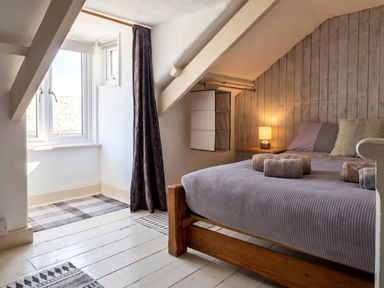 A bedroom with a bed and window at The Old Barn in Manchester