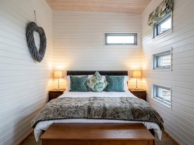 A bedroom with a bed and bedside table at the property