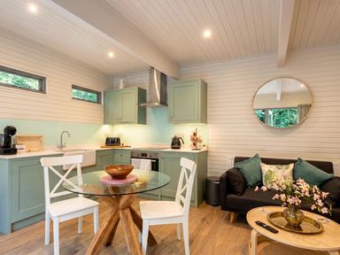 A kitchen with a table and chairs, sink, and appliances at the property in 