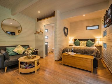 A bedroom with a bed, sofa and table at the property