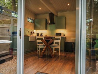 A kitchen with cabinets and dining table at a property