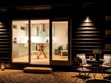 A kitchen with a table and chairs visible from outside at 