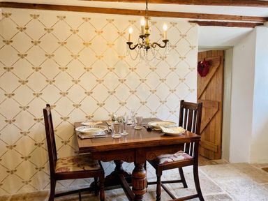 A dining room with a wooden table and chairs at The Old Barn in Manchester