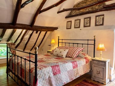 A bedroom with a metal bed and nightstand at The Old Barn in Manchester
