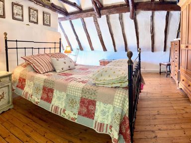 A bedroom with a bed and nightstand at a property