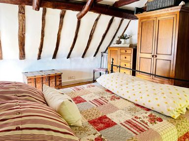 A bedroom with a bed and wooden furniture at the property