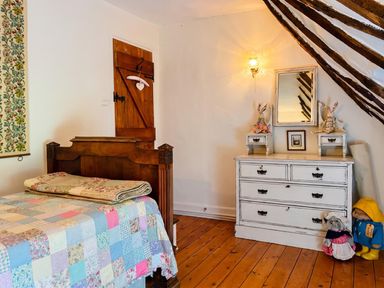 A bedroom with a bed and dresser at The Old Barn in Manchester