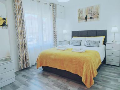 A bedroom with a bed and side tables at 