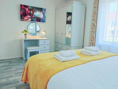 A bedroom with a bed and desk at 