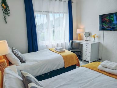 A bedroom with two beds and a desk at 