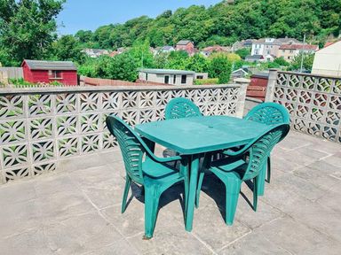 An outdoor seating area with a table and chairs at a property