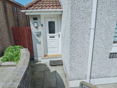 An entrance with a door and doormat at the property in 