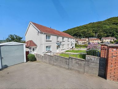 A house with a garage and garden area at the property
