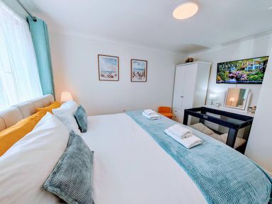 A bedroom with a bed and wardrobe at The Old Barn in Manchester