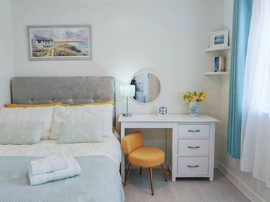 A bedroom with a bed, desk, and chair at the property in location