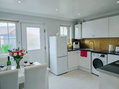 A kitchen with a dining table and flowers at a residential property in 