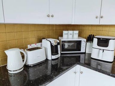 A kitchen countertop with small appliances at a property