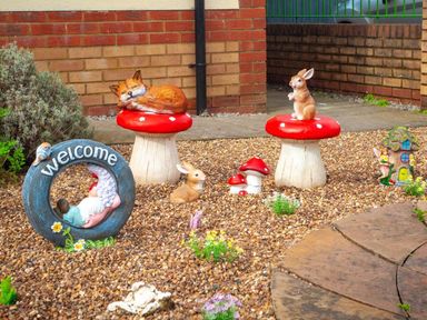 A garden with a fox and a rabbit on mushrooms at 