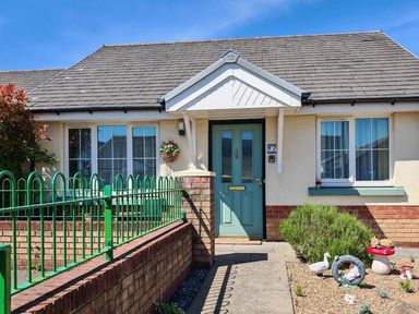 A front entrance of a house with a garden and pathway at 17