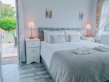A bedroom with a bed and bedside tables at The Old Barn in Manchester