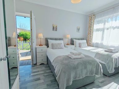 A bedroom with two beds and lamps at the property