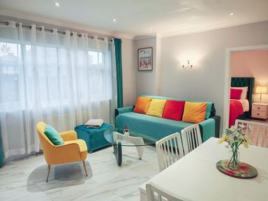 A living room with a sofa, armchair, and coffee table at the property