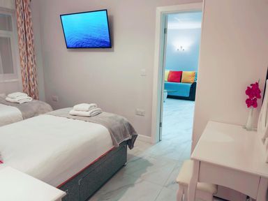 A bedroom with two beds and a television at 