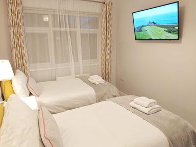 A bedroom with two beds and a television at the property location