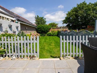 A garden with a lawn and flowers at The Old Barn in Manchester
