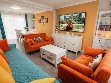 A living room with a sofa, television, and coffee table