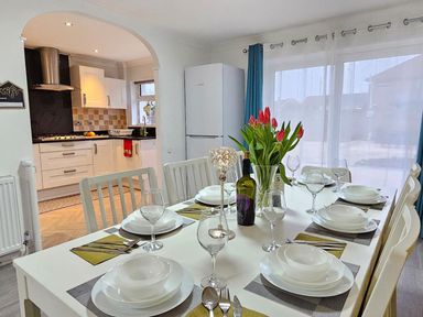 A dining room with a table set for dinner at the property in 
