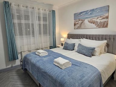 A bedroom with a bed and bedside lamp at The Old Barn in Manchester