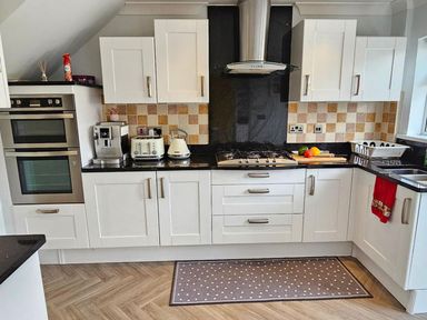 A kitchen with appliances and cabinets at the property