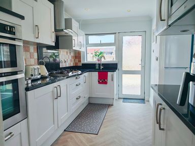 A kitchen with cabinets and appliances at the property
