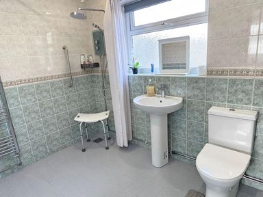 A bathroom with a shower, sink, and toilet at 